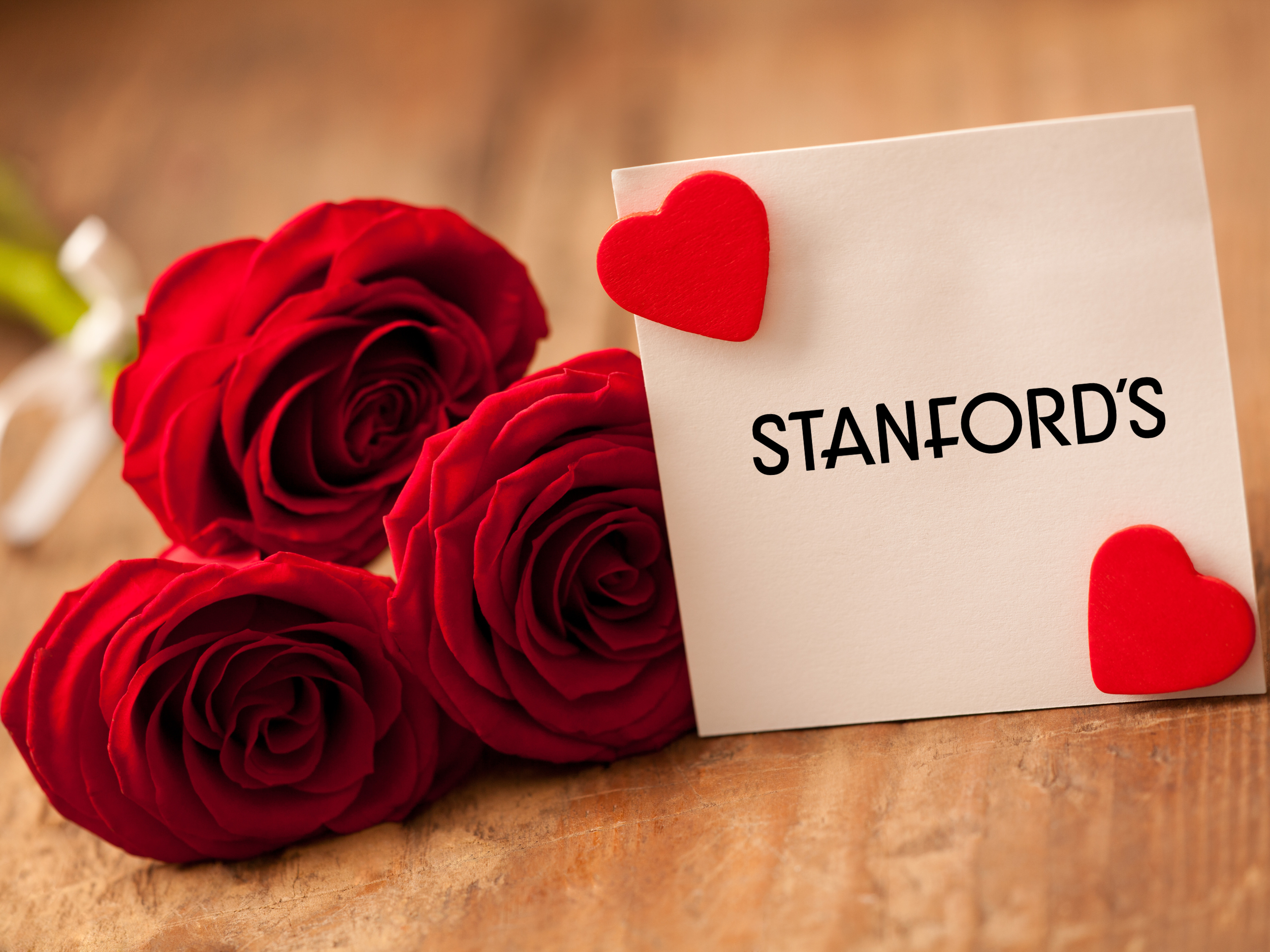 Steakhouse Valentine's Day event roses and card labeled Stanfords